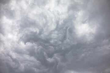Wall Mural - light and dark grey storm clouds waves over the sky before heavy rain. dramatic cumulonimbus, moody 