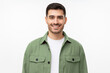 Portrait of smiling young man in green workwear shirt isolated on gray background