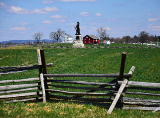 monument  to 73rd new york infantry,  split-rail fence,  and klingle farm at excelsior field in the historical gettysburg battlefield,  pennsylvania