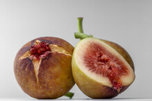 White Background Photo Of Figs Cut In Half.