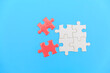 © Tinnakorn - jigsaw puzzle on a blue background. Completing final task, missing jigsaw puzzle pieces and business concept with a puzzle piece missing.