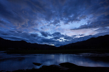 mountain silhouette landscape blue sky clouds after the evening rain river Beautiful evening sky images for a blue background.