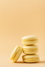 Stack Of Yellow Macaroons With Shallow Depth Of Field On The Yellow Flesh Colored Background.