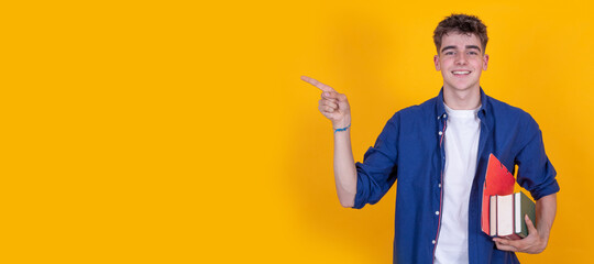 Wall Mural - teen boy with books isolated on background