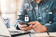 © Thapana_Studio - Concept Internet security and cyber network. businessman's hand works with a key icon virtual screen a cell phone on a computer, laptop, and a digital tablet.
