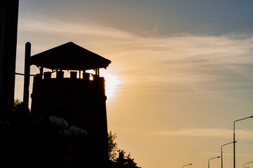 silhouette. tower against sunset sky. unusual architecture for modern city