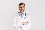 Fototapeta Do pokoju - Handsome doctor smiling and standing on white background
