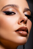 Beautiful Portrait Of Young Woman. make up. Advertisement. Perfect Skin Face. Makeup. Healthy Fresh Skin. Beauty. Close-up of face makeup with shiny glitter on the eyelids and blended arrow