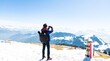Happy time with young tourist blogger  taking photo by smartphone with snow mountain at Switzerland with blue sky background