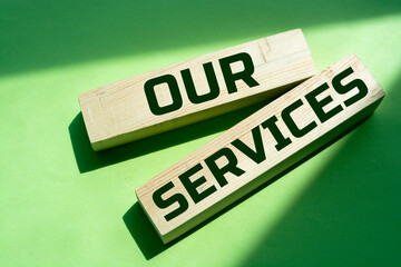 Poster - Wooden blocks with the text 'our services' on beautiful blue background. Business concept, copy space.