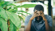 © arrowsmith2 - Unhappy african man having puzzled expression, holding hand on his head. Black guy stressting and headache