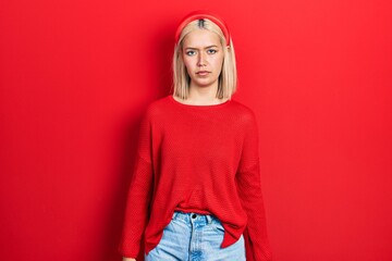 Sticker - Beautiful blonde woman wearing casual red sweater depressed and worry for distress, crying angry and afraid. sad expression.