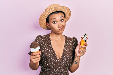 Canvas Print - Beautiful hispanic woman with short hair eating ice cream cones clueless and confused expression. doubt concept.