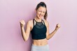 © Krakenimages.com - Young brunette woman wearing sportswear very happy and excited doing winner gesture with arms raised, smiling and screaming for success. celebration concept.
