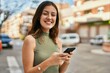 © Krakenimages.com - Young caucasian girl smiling happy using smartphone at the city.