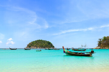 Wall Mural - wooden traditional boat at kata beach with crystal clear water, famous tourist destination and resor