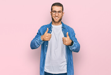 Sticker - Young caucasian man wearing casual clothes success sign doing positive gesture with hand, thumbs up smiling and happy. cheerful expression and winner gesture.