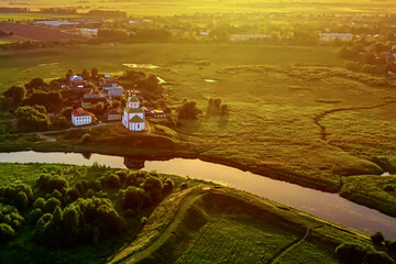 Wall Mural - Aerial drone view of the church of Elijah the Prophet at the Kamenka river, Russia. Summer sunny day sunset