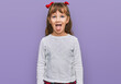 Little caucasian girl kid wearing casual clothes sticking tongue out happy with funny expression. emotion concept.