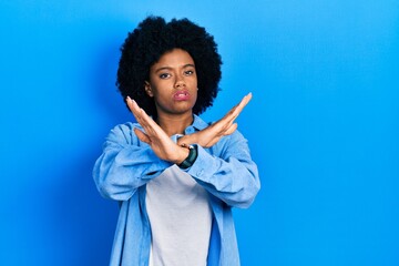 Wall Mural - Young african american woman wearing casual clothes rejection expression crossing arms and palms doing negative sign, angry face