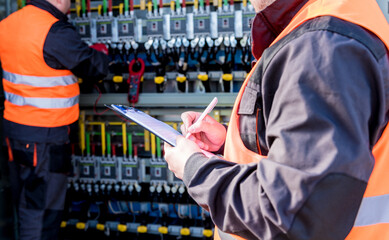 Wall Mural - checking the operating voltage levels of the solar panel switchgear compartment