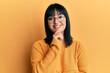 © Krakenimages.com - Young hispanic woman wearing casual clothes and glasses smiling looking confident at the camera with crossed arms and hand on chin. thinking positive.