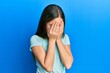 © Krakenimages.com - Beautiful brunette little girl wearing casual white t shirt with sad expression covering face with hands while crying. depression concept.