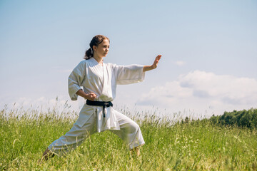 teen girl training karate kata outdoors