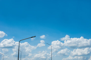 Wall Mural - Many lampposts and white clouds in the blue sky.