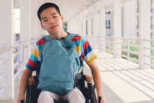 Confident Asian Disabled Teen Boy On Wheelchair Determining To Use Wheelchair By Himself, Lifestyle In The Education Age Of Special Need Kid, Muscle And Self-esteem Development Concept.
