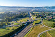 New motorway junction in Poland on national road no 7, E77, called Zakopianka.  Overpass crossroad with traffic circles, slip roads and viaducts near Rabka. Aerial view. Far view of Tatra Mountains