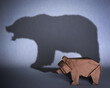 Concept of hidden potential. A paper figure of a bear that fills the shadow of a big bear grizzly bear. 3D illustration
