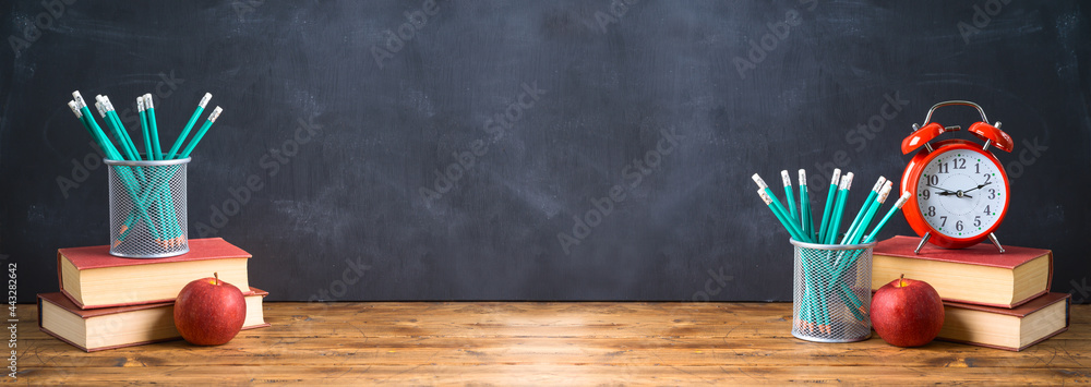 Back to school background with pencils, apple, books and alarm clock ...