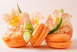 beige french macaroon cookies, yellow flower on a light background