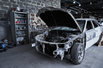 Repair of an old broken car at auto service