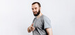 © Daria Lukoiko - Portrait of cheerful young handsome man smiling looking at camera pointing finger forward on white background with space for advertising mock up