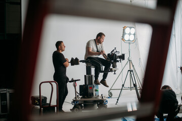 Wall Mural - Director of photography with a camera in his hands on the set. Professional videographer at work on filming a movie