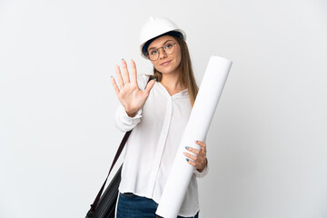 Young Lithuanian architect woman with helmet and holding blueprints isolated on white background counting five with fingers