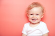 © yana136 - portrait caucasian curly blond smiling baby girl with two teethon pink background wearing in white t-shirt. copy space.
