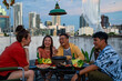 Group of Diversity Asian millennial people friends enjoy outdoor dinner party with eat korean food barbecue grill and alcoholic drink at rooftop for meeting reunion and holiday celebration together