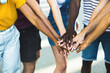 Close up multi ethnic group of young students stacking hands together - Millennial people celebrating together outdoor - College students teamwork stacking hand Concept