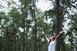 © Farknot Architect - Portrait image of a happy woman with arms rising in the park