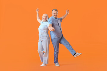 Canvas Print - Dancing mature couple on color background