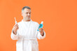 © Pixel-Shot - Mature man with tooth brush and mouth rinse on color background