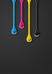 cmyk ink drops on black paper background