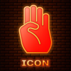 Canvas Print - Glowing neon Indian symbol hand icon isolated on brick wall background. Vector