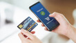 © Suriyawut - Young woman holding credit card and using smart phone for online shopping, internet banking, e-commerce, spending money, working from home concept