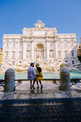 Trevi Fountain, Rome, Italy. City trip couple on a city trip in Rome, view of Di Trevi fountain. Asian woman and European man on a city trip in Rome