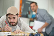 © auremar - man worker with a pencil makes notes in workshop