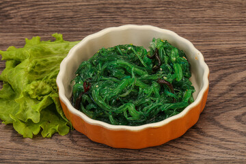 Green Chuka Seaweed Salad Isolated on White Background Top View. Wakame Sea Kelp Salat